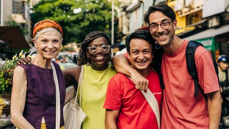 Intrepid leader and travellers of varied age stopping for a photo on the streets of Hanoi