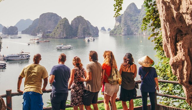 TVPHC - Group in cave overlooking boats in Ha Long Bay, Vietnam