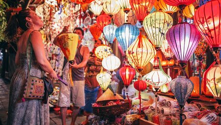 Passenger looks at lanterns from street vendor in Hoi An