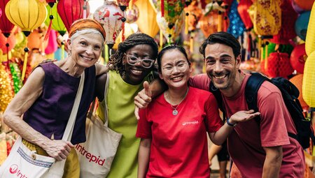 Group of Intrepid travellers and leader on walking tour of Hanoi