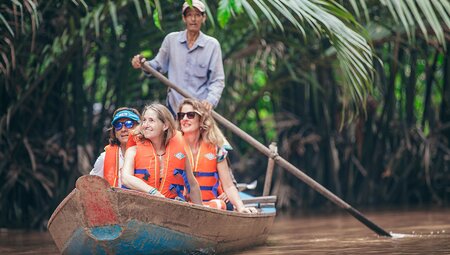 Vietnam insights with Peregrine Adventures: Take a traditional boat through the Mekong Delta