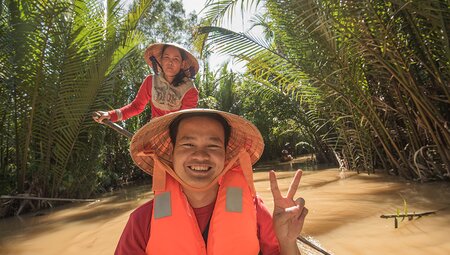 Passenger on a boat ride on the Mekong River, Vietnam on an Intrepid Travel tour.
