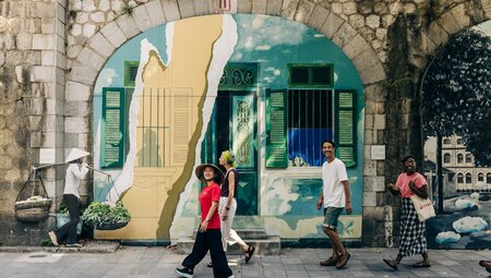 Intrepid leader and travellers walking the streets of Hanoi