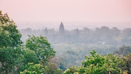 Angkor Wat seen from a distance in the mist in Cambodia
