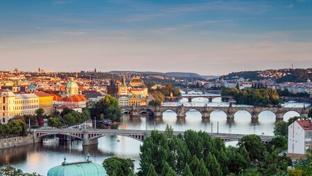 Aerial view of Prague Old Town with bridges over the river Vlatva in summer with sunset hitting the city