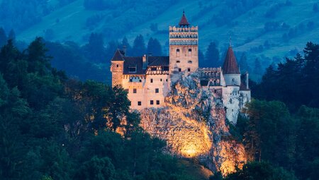 Bran Castle, commonly known as Dracula's Castle, lit from below at night in Transylvania Romania