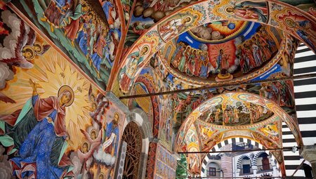 Religious murals adorn every surface of Rila Monastery's main church in Bulgaria