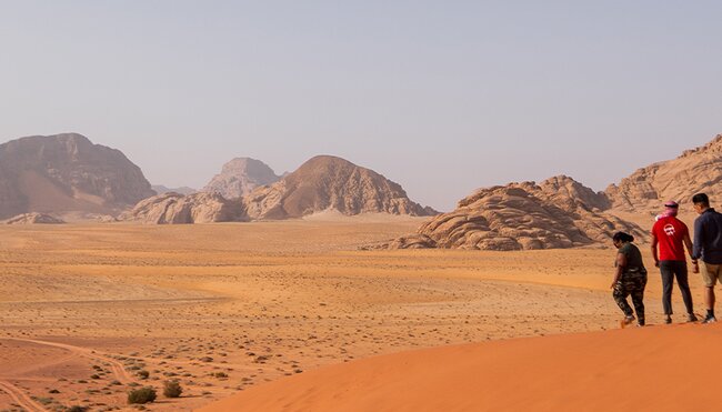 XEPJC - Group walking through desert and sand dunes, Wadi Rum