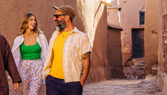 Travellers exploring Ait Benhaddou with local leader in Morocco