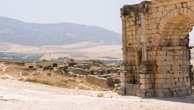 XMPSC - Group of travellers walking through Volubilis ruins, Morocco