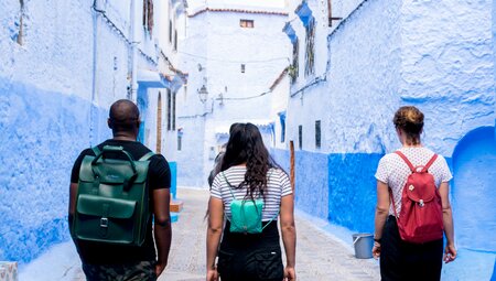 Travellers walking down the blue painted lanes of Chefchaouen