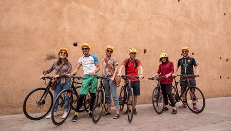 Group of Intrepid travellers prepared to head out from Marrakech while cycling