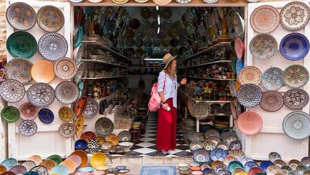 Young woman exploring the brightly coloured medinas of Essaouira, Morocco