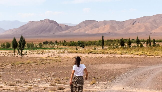 Female traveller walking towards the Atlas Mountains in Morocco