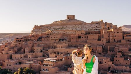 Travellers and leader overlook the city of Ait Benhaddou, Morocco