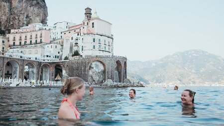 travellers swimming in Italy