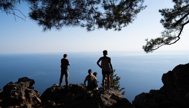 Intrepid travellers look out over the Aegean sea at the end of the Agia Irini Gorge hike on Crete