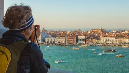 Intrepid travellers looks out over the city of Venice from San Giorgio Bell Tower