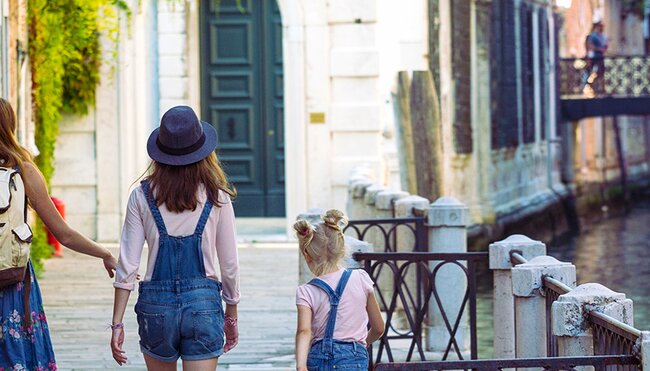 Mum and daughters walking around Venice. Italy