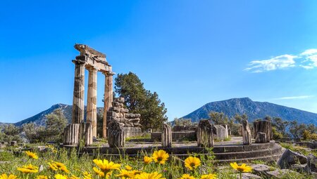 Temple of Athena ruins with stone wall in Delphi, Greece