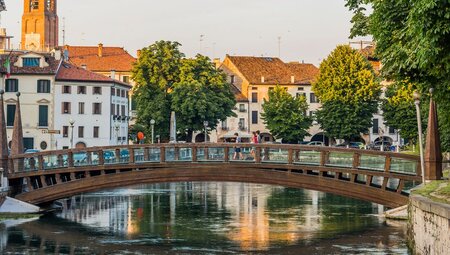 Intrepid travelllers and leader cross one of Treviso's iconic bridges