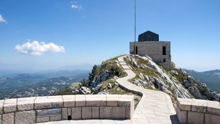 Stone path leading up to the Njegos Mausoleum in Cetinje, Montenegro on a clear blue day