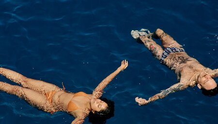Travellers floating in the blue water on a boat trip in Korcula, Croatia