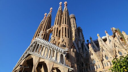 Grand view of the Sagrada Familia Church towers against a blue sky backdrop