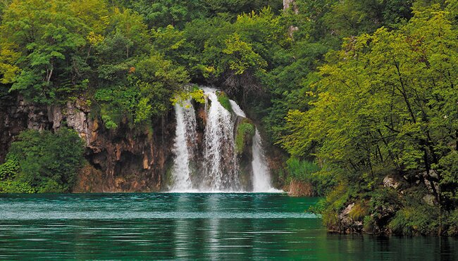 Beautiful waterfall surrounded by forest in Plitvice National Park, Croatia