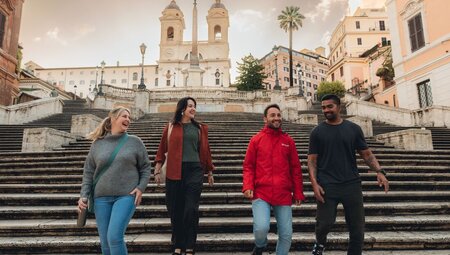 Leader and travellers walking down the Spanish Steps in Rome, Italy