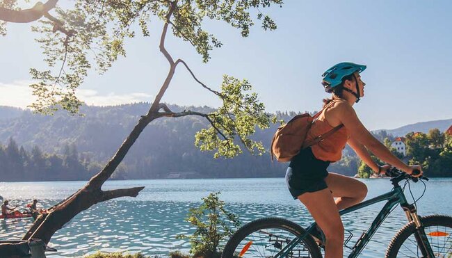 Traveller rides bike around Lake Bled
