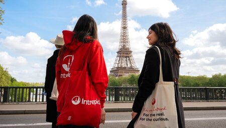 Three travellers enjoying a view of the Eiffel Tower in Paris, France.