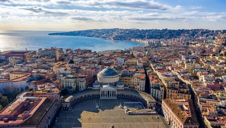 Aerial view of the city of Naples wiith Piazza de Plebiscito in foreground and harbour beyond the city