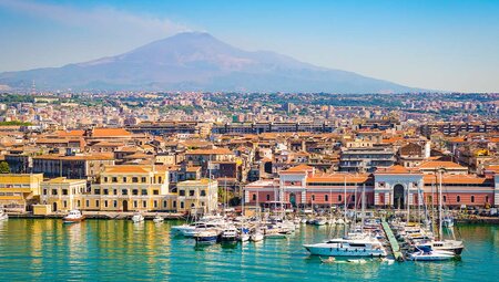 View of the harbour in Catania with Mt Etna in the background, Sicily, Italy