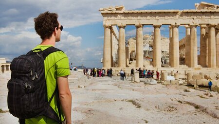 Intrepid travellers looks out at the Parthenon in Athens Acropolis