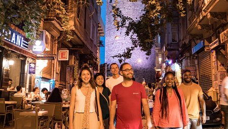 Intrepid group with leader headed by leader explore the streets of Instanbul at night