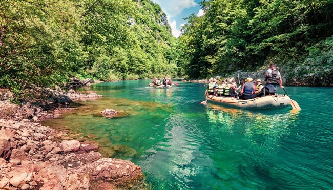 View from the shore as travellers set off to whitewater raft in Tara Canyon, Durmitor National Park in Montenegro