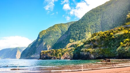Idyllic beach surrounded by towering cliffs of Madeira in the North Atlantic