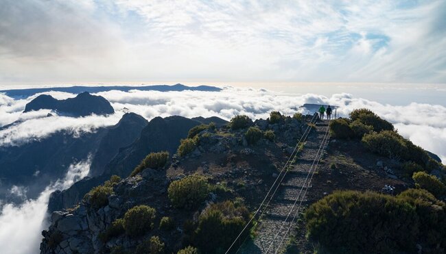 Intrepid travellers look out after hiking to the top of Madeira at Pico Ruivo