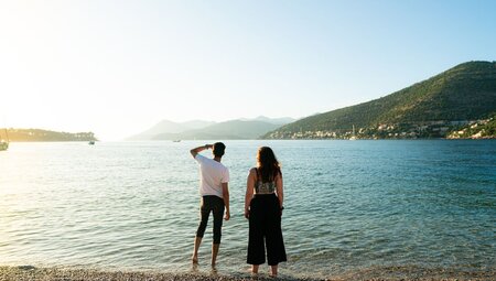 Two 18 to 35s travellers look out before sunset on a Dubrovnik beach