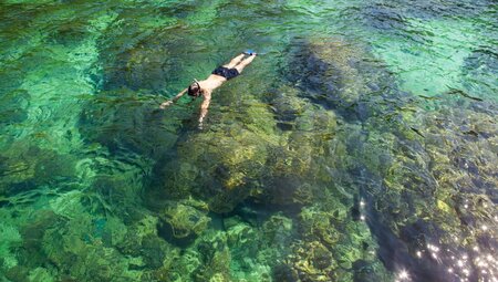 18 to 35 traveller snorkelling off Corfu looking down into the water in Greece
