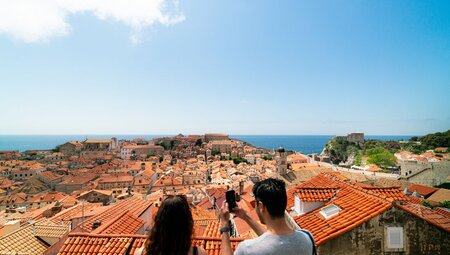 Intrepid travellers take a photo looking out over Dubrovnik Oldtown in Croatia