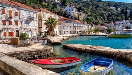 Waterfront of Rose, Montenegro with boats anchored in the marina