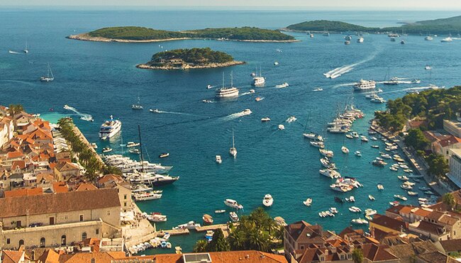 Aerial drone shot view of sailing boats cruising the Dalmatian Coast, Croatia