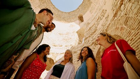 Upwards view of travellers and interior of Diocletian's Palace, Split, Croatia