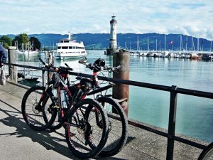Zwei Fahrräder an einem Brückenpfeiler angelehnt, Schiffe im Hintergrund