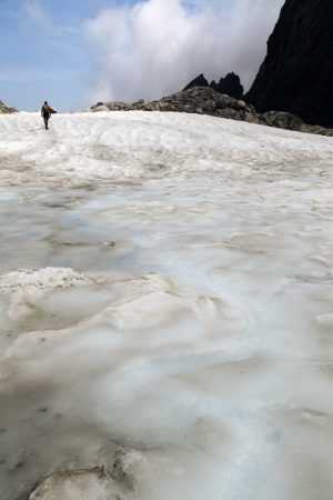 Steile Eisfläche mit einem Hochtourengeher weiter oben.