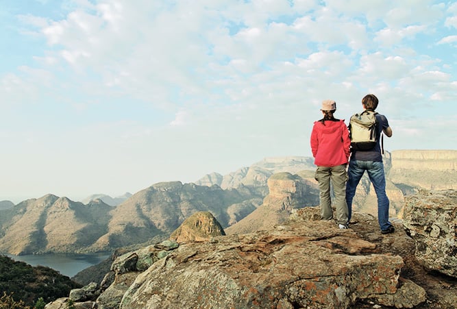 Zwei Wandernde auf einem Felsen über dem Blyde River in Südafrika
