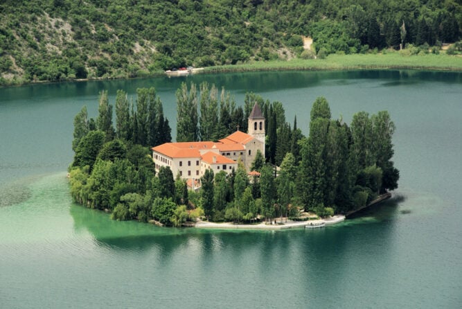 Kloster auf einer Insel in einem smaragdgrünen See