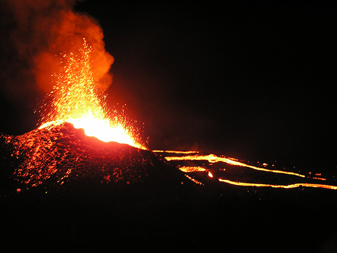 feuerspeiender vulkan in der nacht